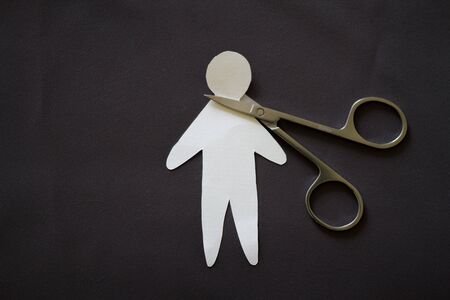 Cutting head of paper person. Murder conceptの写真素材