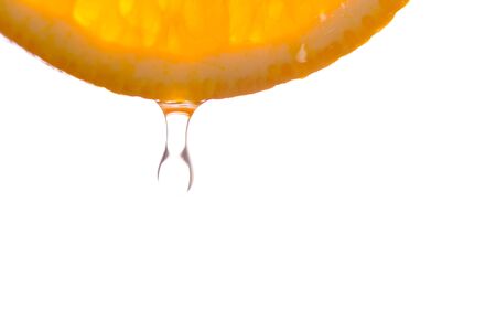 Orange fruits fall deeply under water with splashesの写真素材