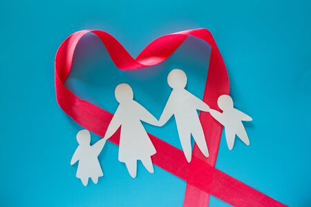 Paper family on blue background with copy spaceの写真素材