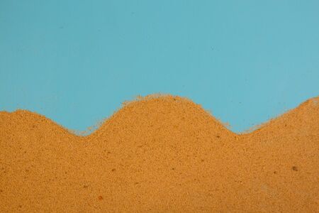 sand on blue background with copy spaceの写真素材