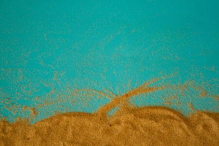 sand on blue background with copy space