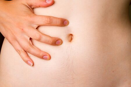 Woman Stomach Ache. Woman holding her naked stomachの写真素材