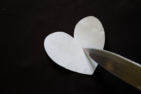 Stabbed Heart on black background. Broken heart conceptの写真素材