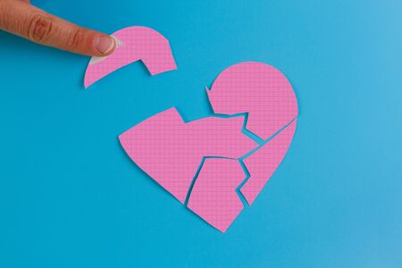 Broken heart concept image. Paper broken heartの写真素材