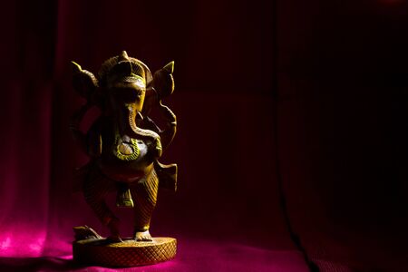 Wooden Ganesha figurine with copy space. High contrastの写真素材