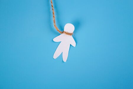 Hang oneself concept. Paper person hang on a ropeの写真素材