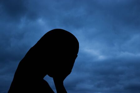 Lonely girl crying in the rainの写真素材