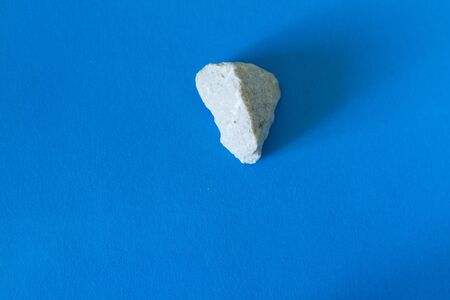 White stone with copy space on blue backgroundの写真素材