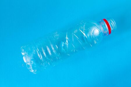 Plastic bottle on blue background. Empty