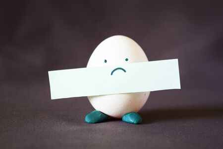 Egg character stand on grey backgroundの写真素材