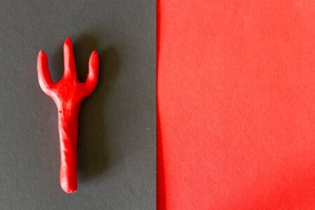 Trident on red background. Halloween concept imageの写真素材