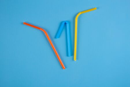 Cocktail straw on blue background with copy spaceの写真素材
