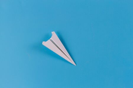 Paper airplane on blue background with copy spaceの写真素材