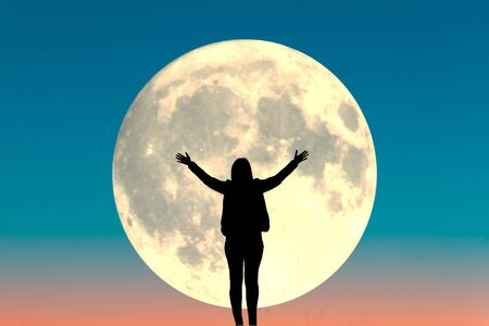 Silhouette of a woman. Full moon backgroundの写真素材