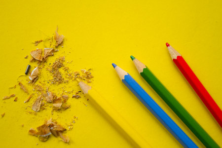 Yellow pencil on yellow background with copy space