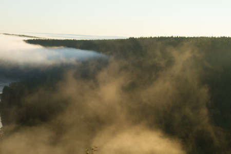 Beautiful foggy sunrise over hillsの写真素材