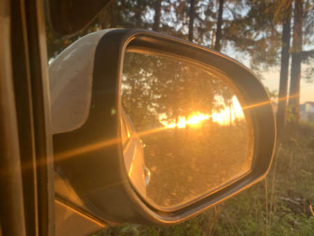 Beautiful sunshine in a side mirror of a carの写真素材
