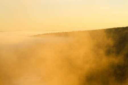 Beautiful foggy sunrise over hills