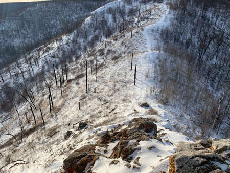 Winter landscape with hills and distant villageの写真素材
