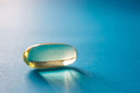 Close up of transparent pill on blue backroundの写真素材