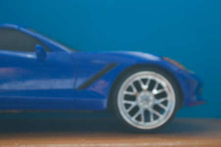 Toy car in vivid blue color. Defocused