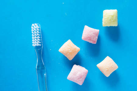 Candies and toothbrush. caries conceptの写真素材