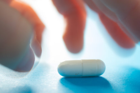 Taking a pill concept. Nervous hand trying to take a pillの写真素材
