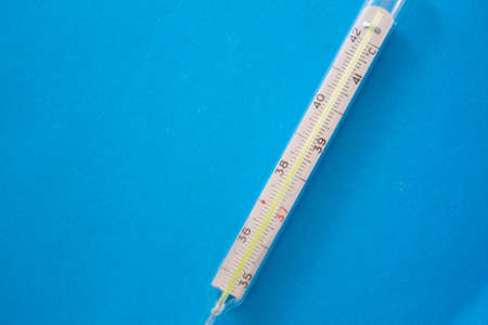 Thermometer on blue background. copy space