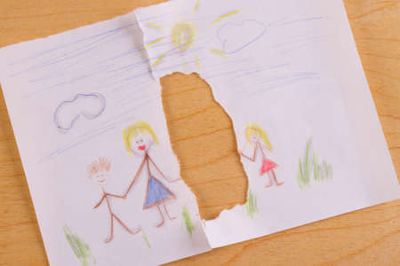 Divorce concept image. Child family picture turn to pieces