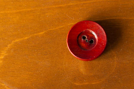 Wooden button on wooden background. copy spaceの写真素材