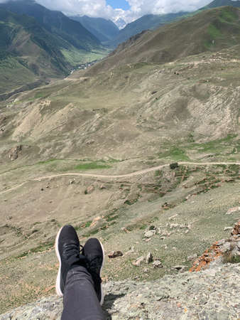 Legs of a woman tourist in mountains