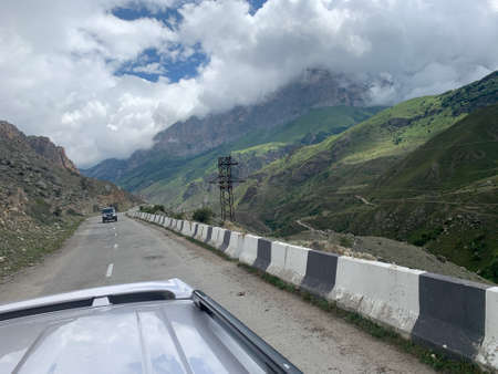 Road goes among mountains and canyon. view from a car