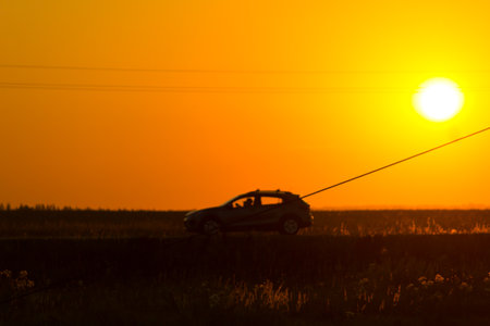 Silhouette of a car. Against sunset light. Blurredの写真素材