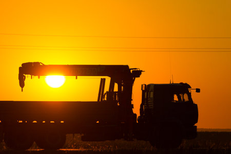 Silhouette of scaffold truck against sunlightの写真素材