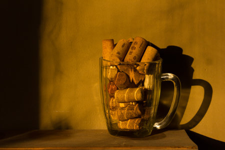 Glass of beer with wine corks in itの写真素材