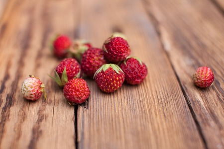 Forest strawberries on a wooden table. macroの写真素材