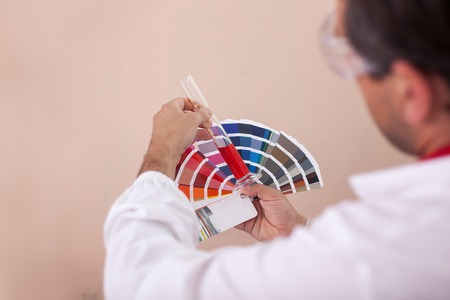 man checks the color of paint on the color a fanの写真素材