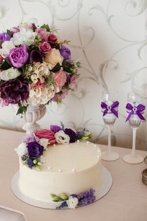 Wedding decorations. Bouquets of flowers and cake on the chest of drawersの写真素材