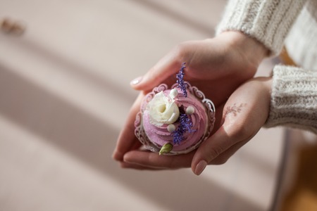 Cake with cream in hands. view from above