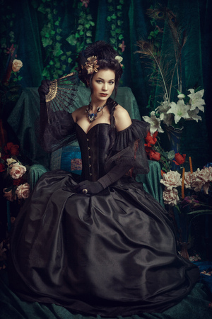 Girl in a black dress on a green background