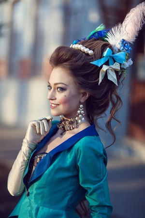 Beautiful caucasian girl dressed in the style of the Renaissance. Photo in blue tonesの写真素材
