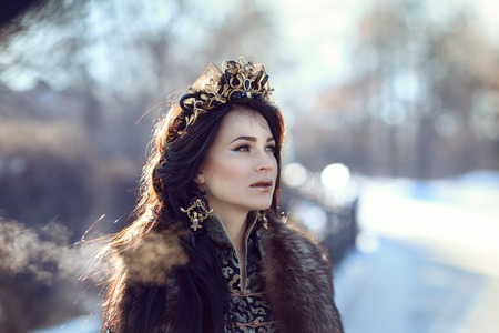 Portrait of a brunette in furs in a winter frosty day