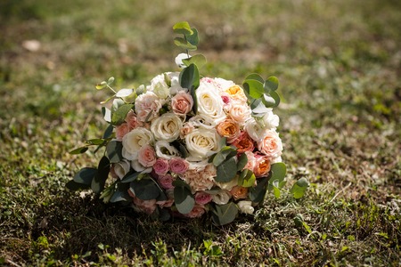 lonely wedding bouquet lies on lawn grassの写真素材