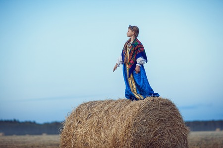 Little girl in Russian costume in the fieldの写真素材
