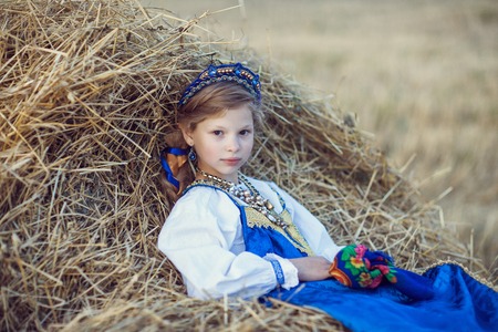 Little girl in Russian costume in the fieldの写真素材