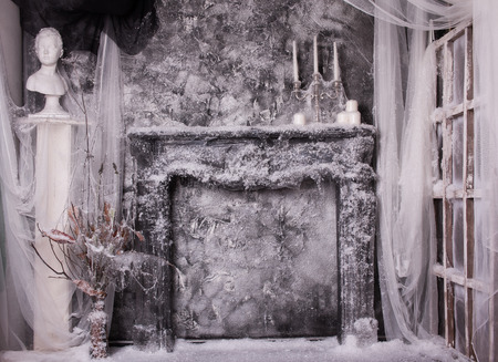 Snow-covered fireplace with candles in gloomy colorsの写真素材