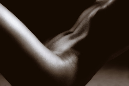 The nude part of the body is the abdomen. Black and white photoの写真素材