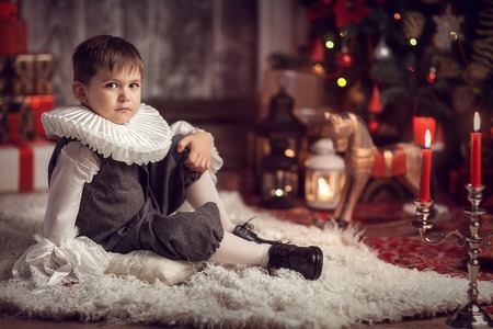 boy in a vintage suit with an English collar-cutter at a Christmas treeの写真素材