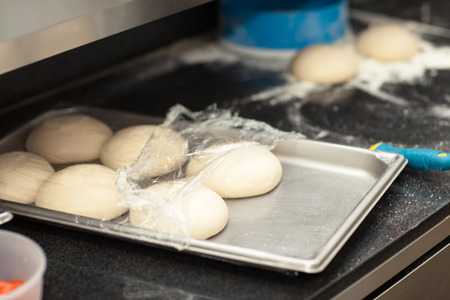 dough on a pizza trayの写真素材