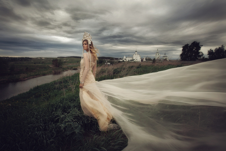 Girl in white dress on background of the Churchの写真素材